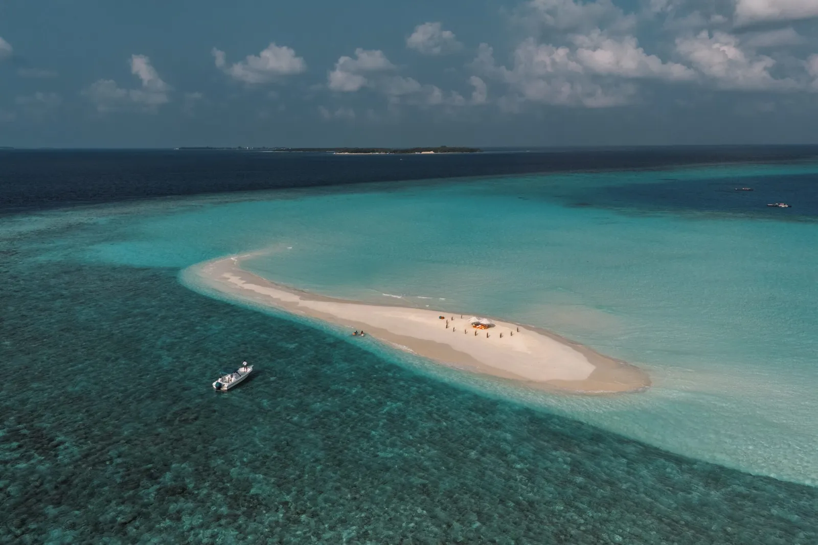 The sandbank out at sea, a boat moored beside it