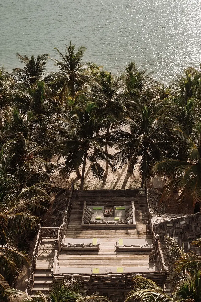 The Crab Shack’s timber terrace among the palms, looking over the water