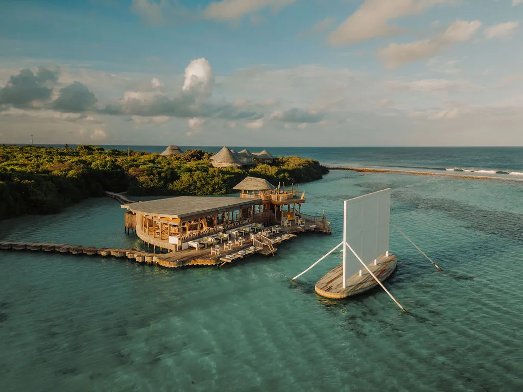 Director’s Cut over the lagoon from above, the cinema screen on the water beside it