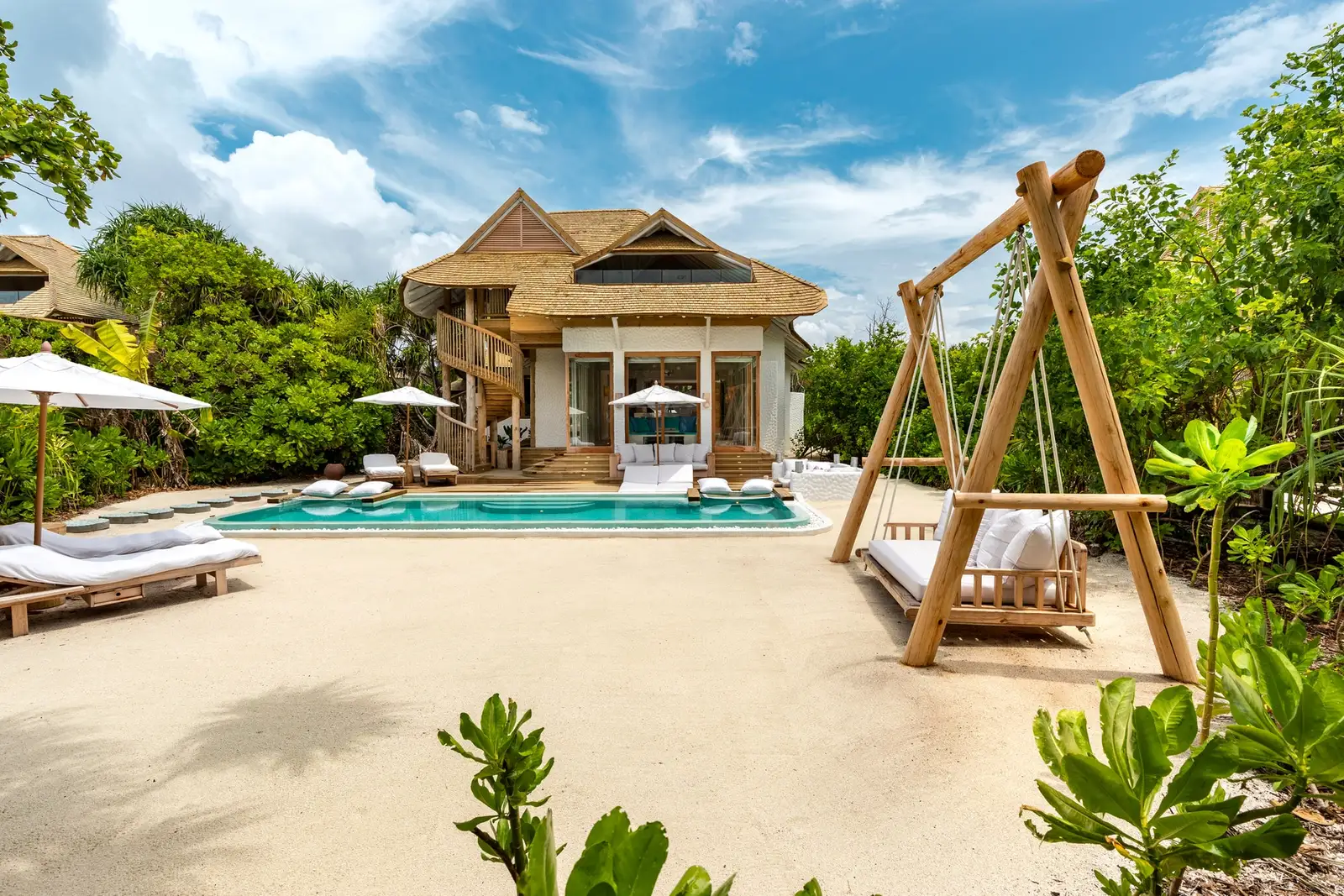 The 1 Bedroom Beach Hideaway: the villa on the sand, its pool and a timber swing