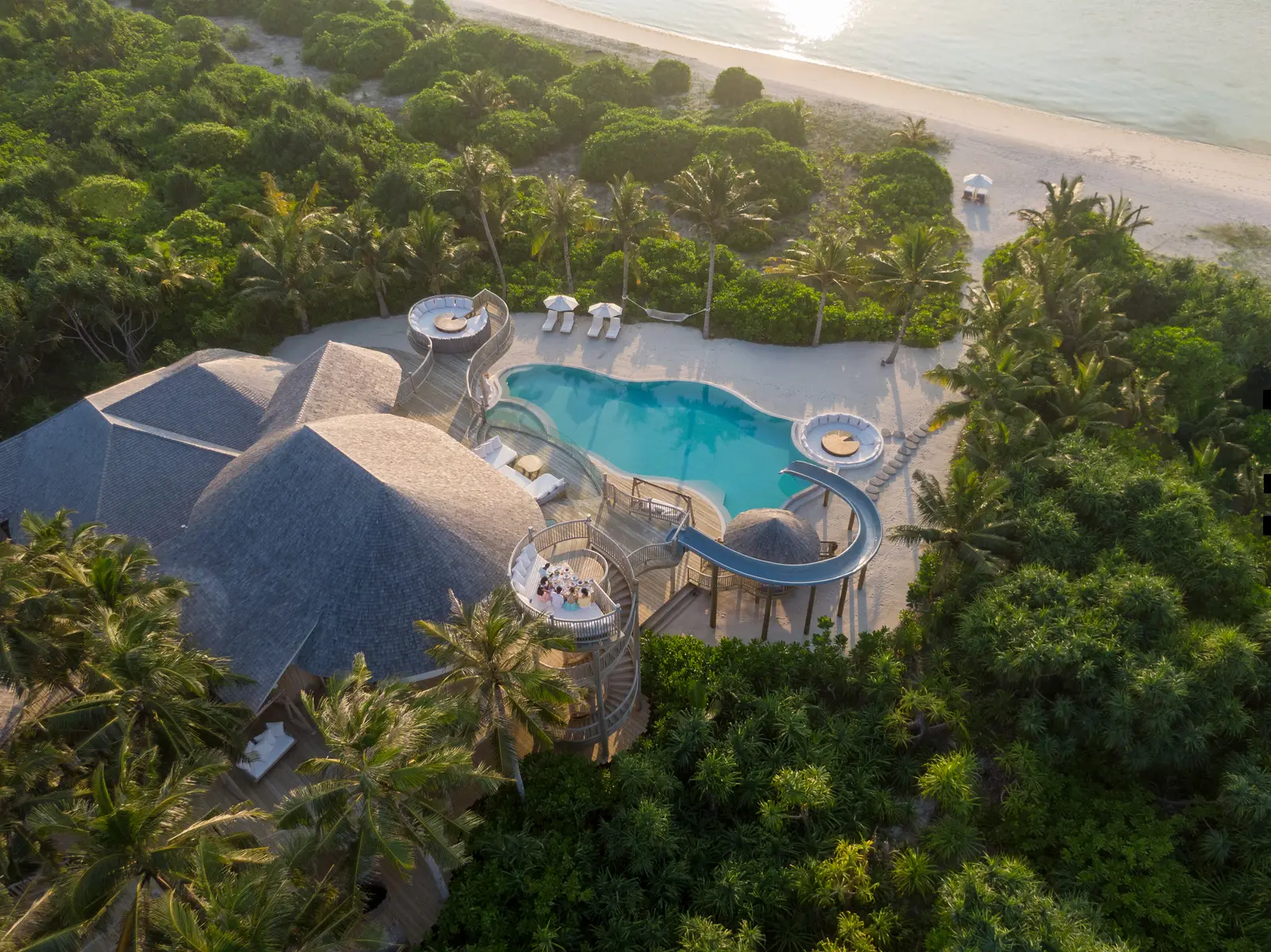 Villa 34 from the air in the greenery: the pool and the spiral slide