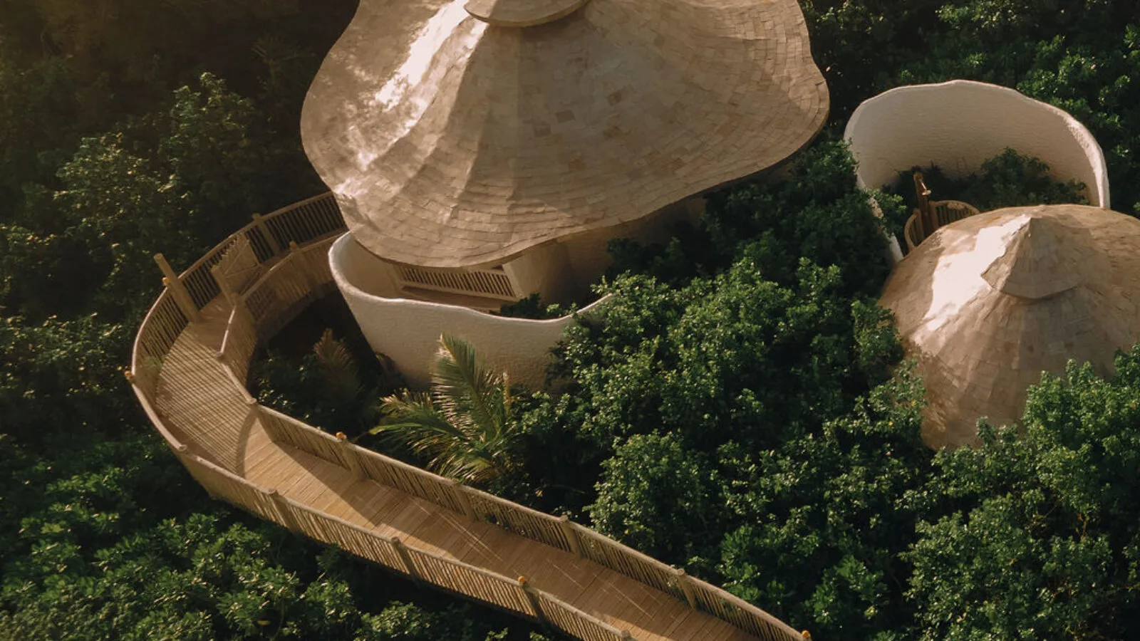 The domes of Soneva Soul among the trees, joined by timber walkways