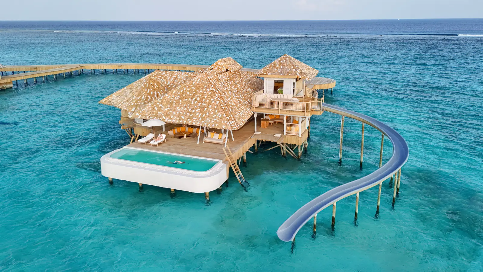 The One-Bedroom Horizon Overwater Villa on the lagoon, with its pool on the deck and the slide into the water.