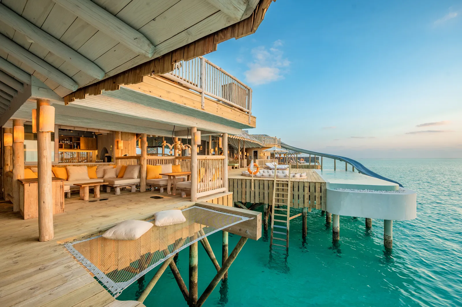 A Sea Loft’s deck with the net slung over the water, the ladder and the slide down to the lagoon.