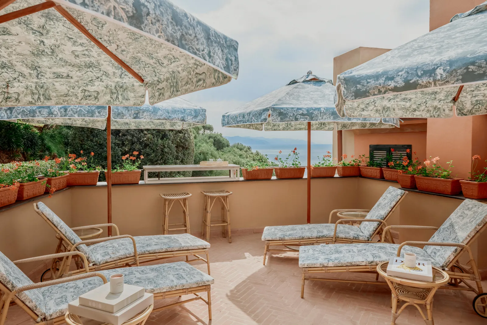 The Dior Spa’s terrace: loungers and parasols in toile de Jouy, pots of geraniums and the sea.