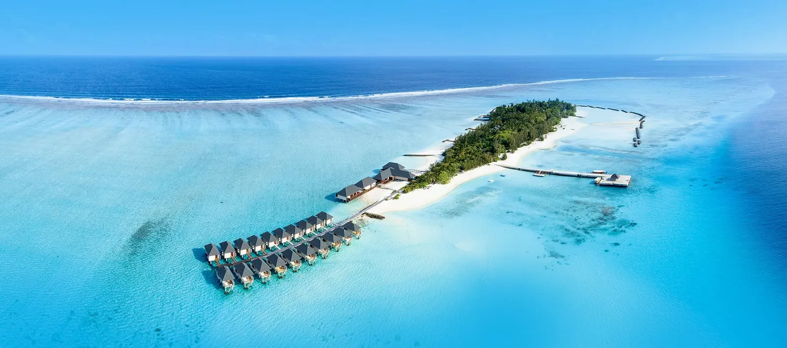The island and row of water villas seen from above.