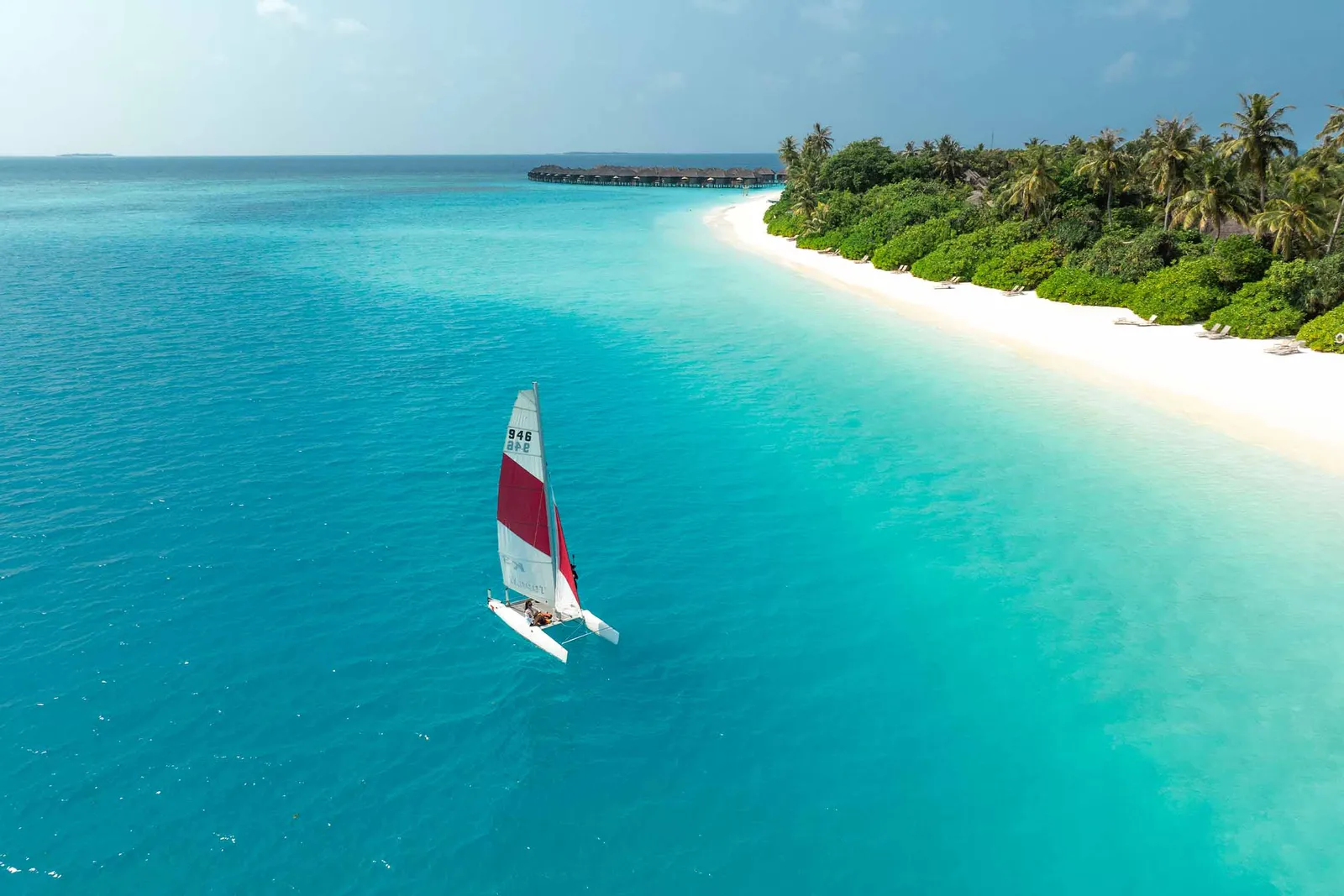 A catamaran in the turquoise lagoon off the island’s long beach.