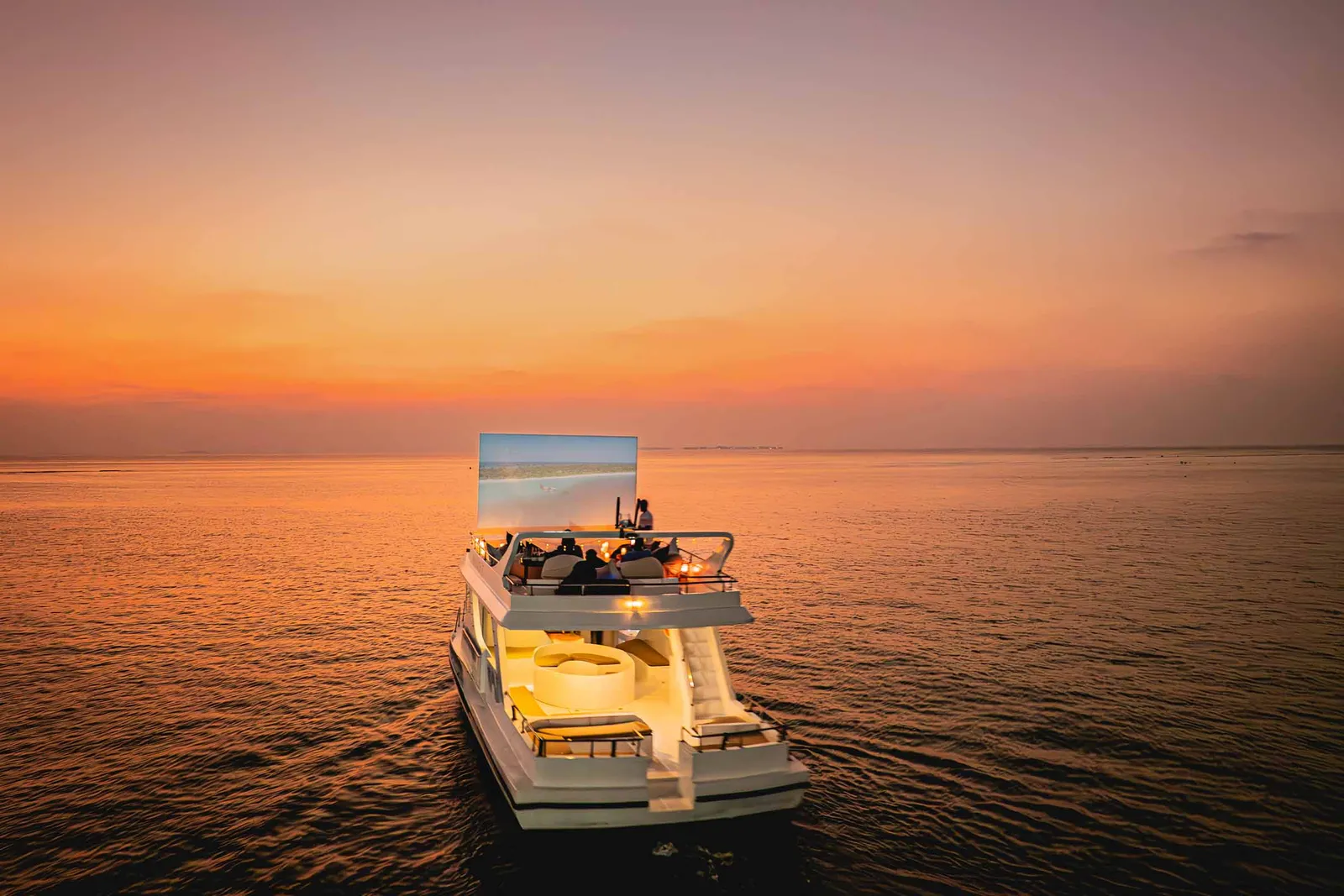 The Cinema by Moonlight dhoni on the sea at sunset, with the screen at its bow.