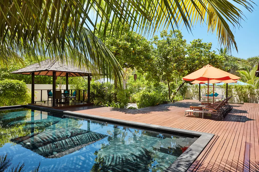 The Hidden Retreat: the large pool, the timber deck and the pavilion in the tropical garden.