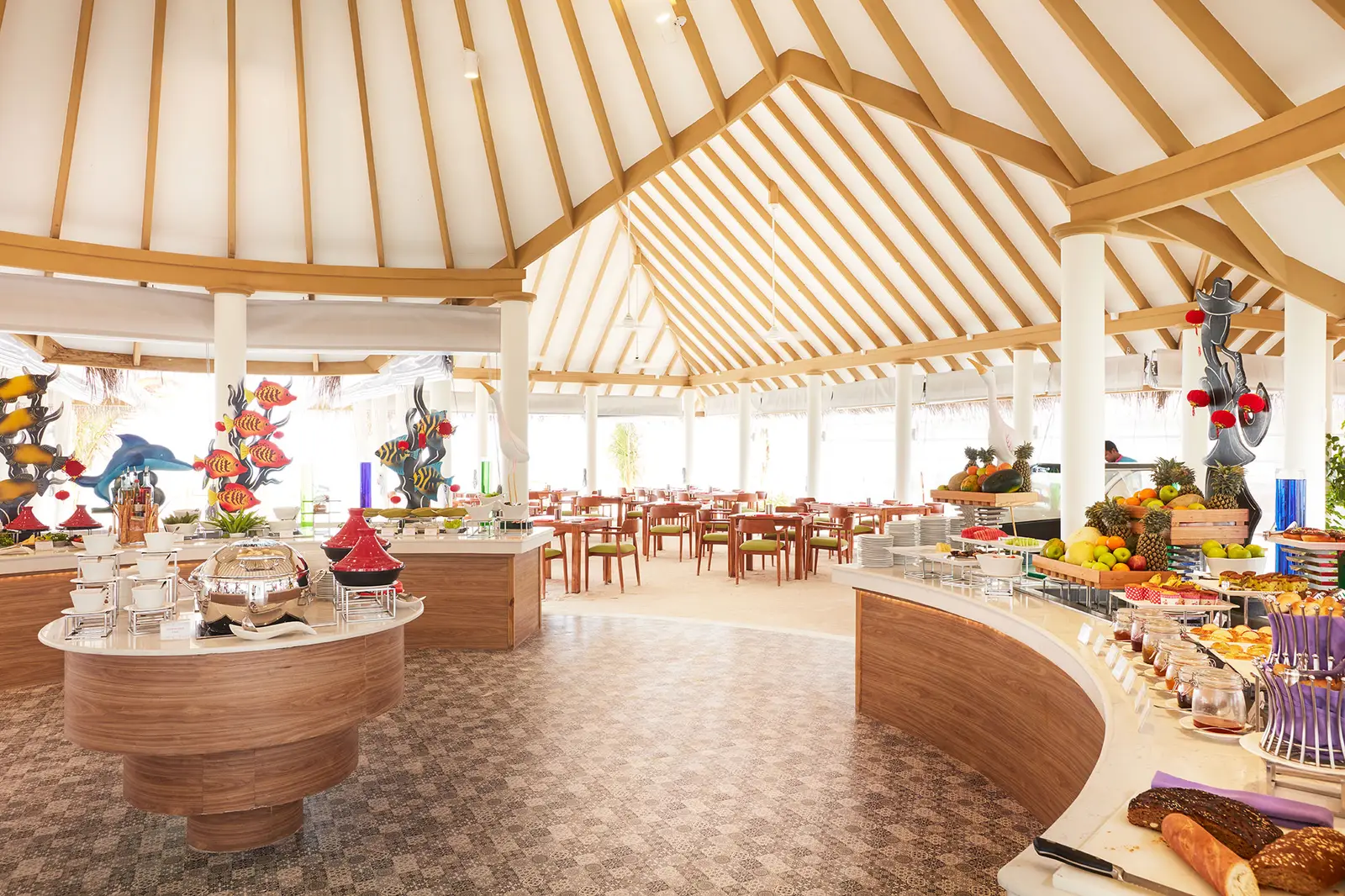 Aqua Orange, the buffet restaurant: the round counter, tables under the timber roof and painted fish hanging above.