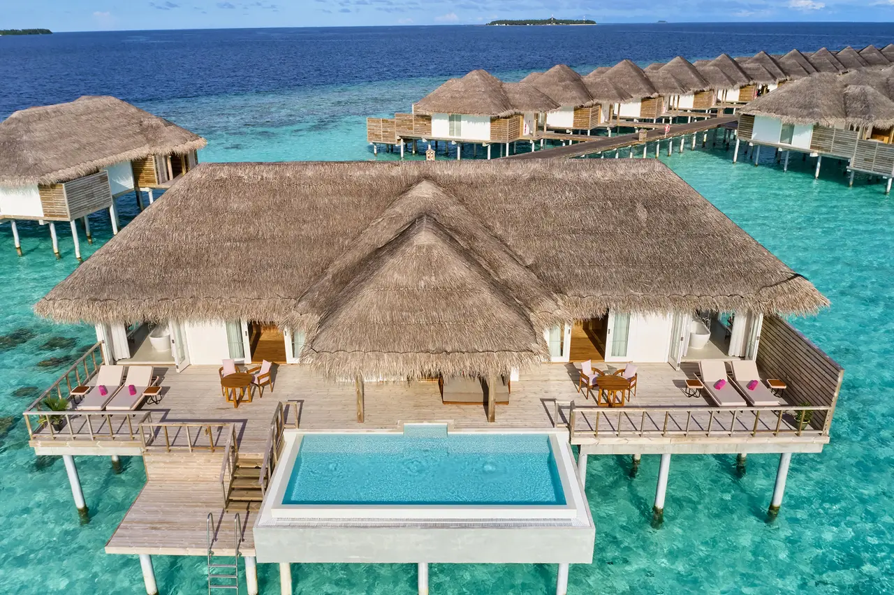 The Two Bedroom Ocean Residence with Pool from above: the broad thatched roof, the pool and the water villas behind.
