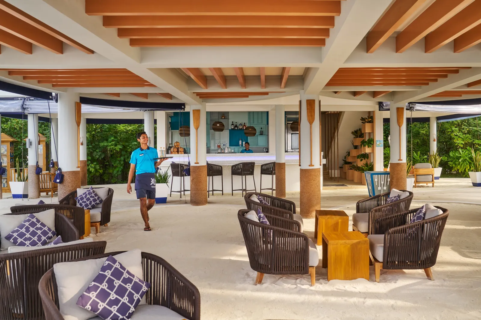 The Romance Bar open onto the sand, with wicker armchairs