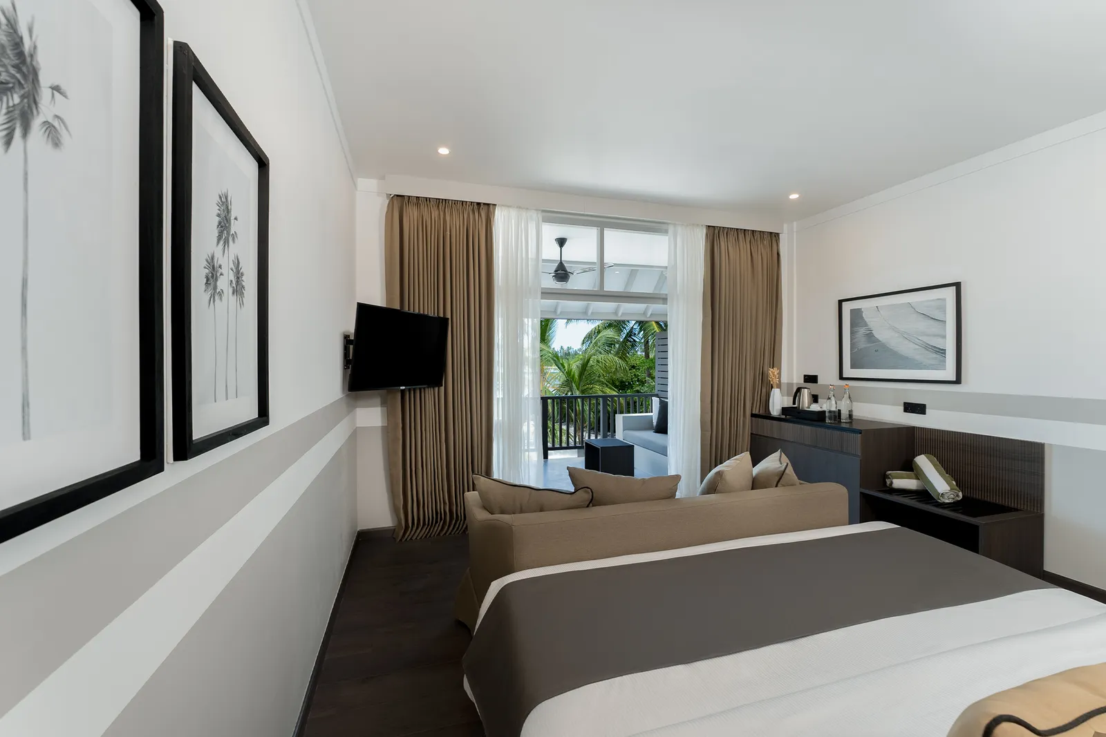 A Beach Pavilion bedroom, the bed and sitting area facing the garden