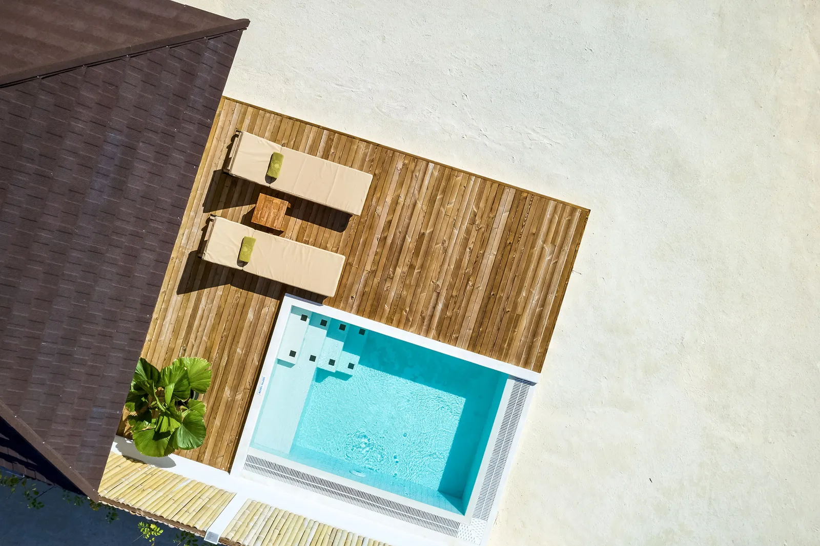 A Grand Beach Villa with Pool deck from above, its pool and loungers