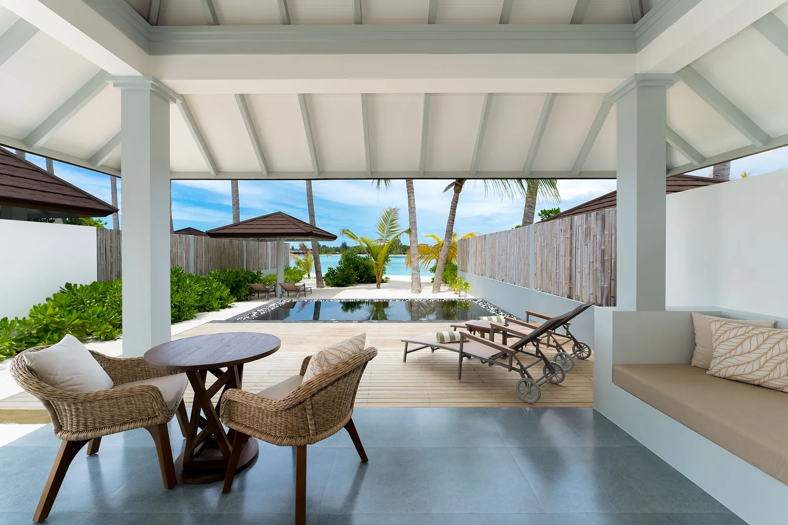 The Grand Beach Suite veranda, its table, loungers and pool