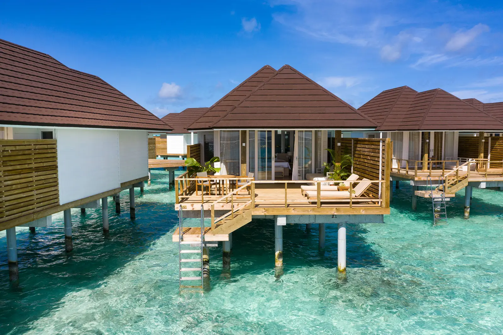 The Grand Water Villas on turquoise water, ladders down into the lagoon