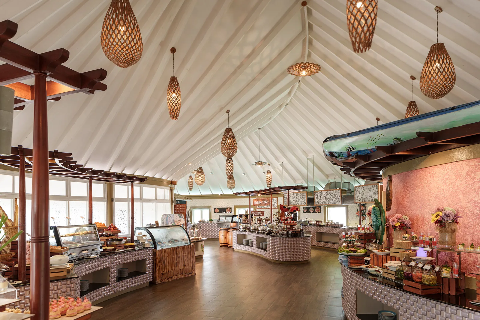 The Aqua’s dining room, with its buffet counters, woven lamps and white tented ceiling.