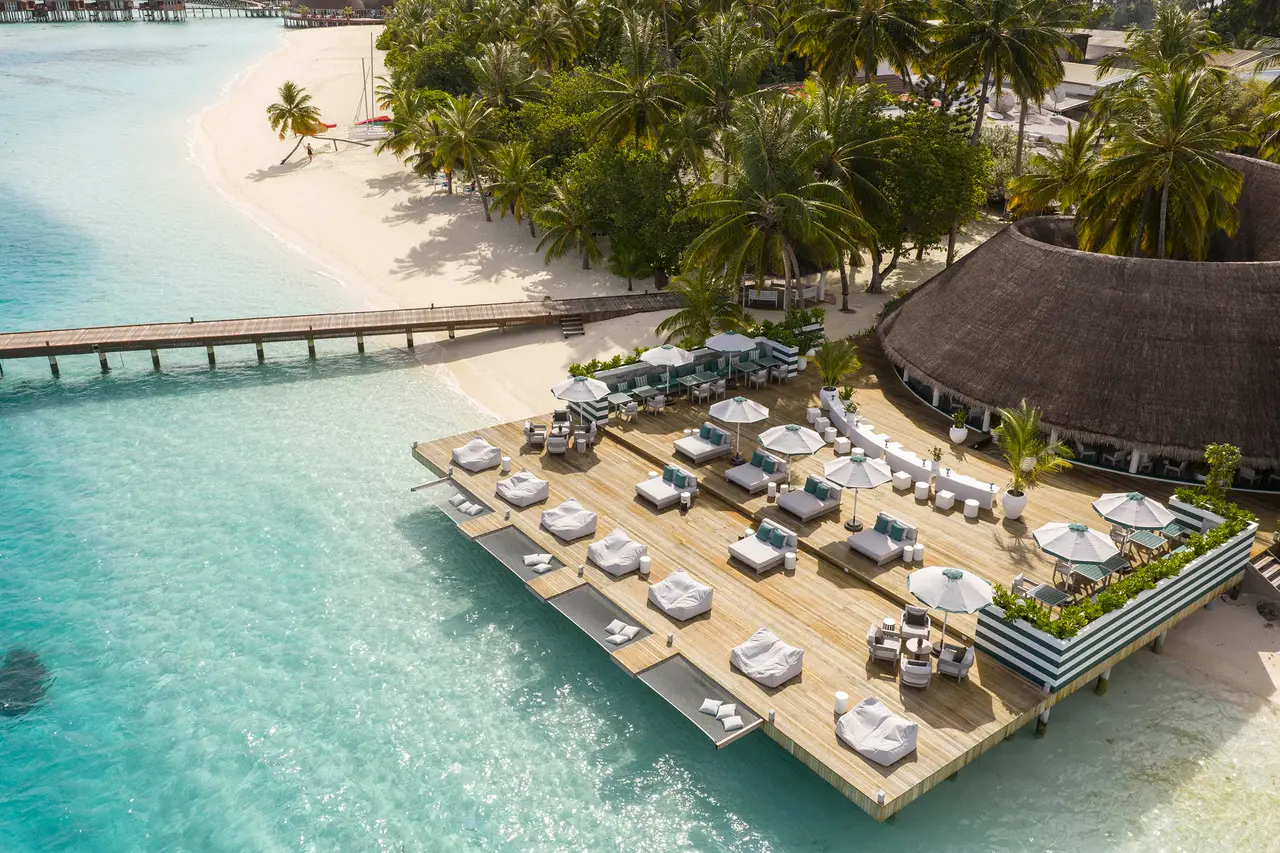 The Nautilus from above: the platform of sofas and parasols over the lagoon, the jetty and the palm-lined beach.