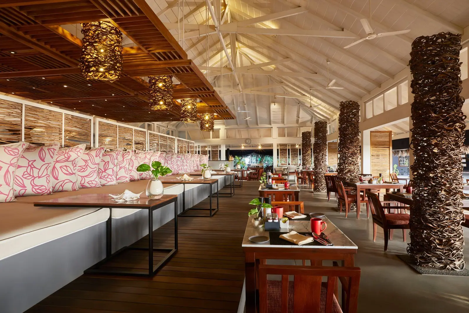 Bokkura’s long, bright dining room, with flowered banquettes, laid tables and timber columns.