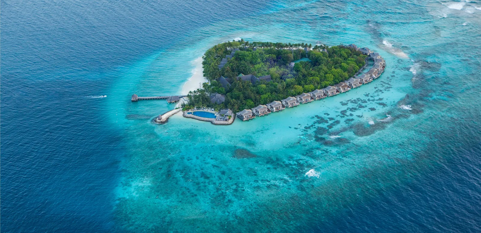 Hembadhu from above: the heart-shaped green island, its pale lagoon and the line of water villas.