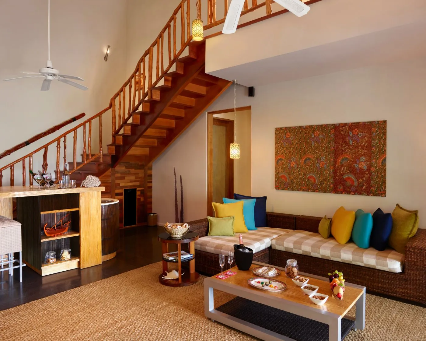 The Nirvana Presidential Suite’s living room, with the wooden staircase up to the upper floor.