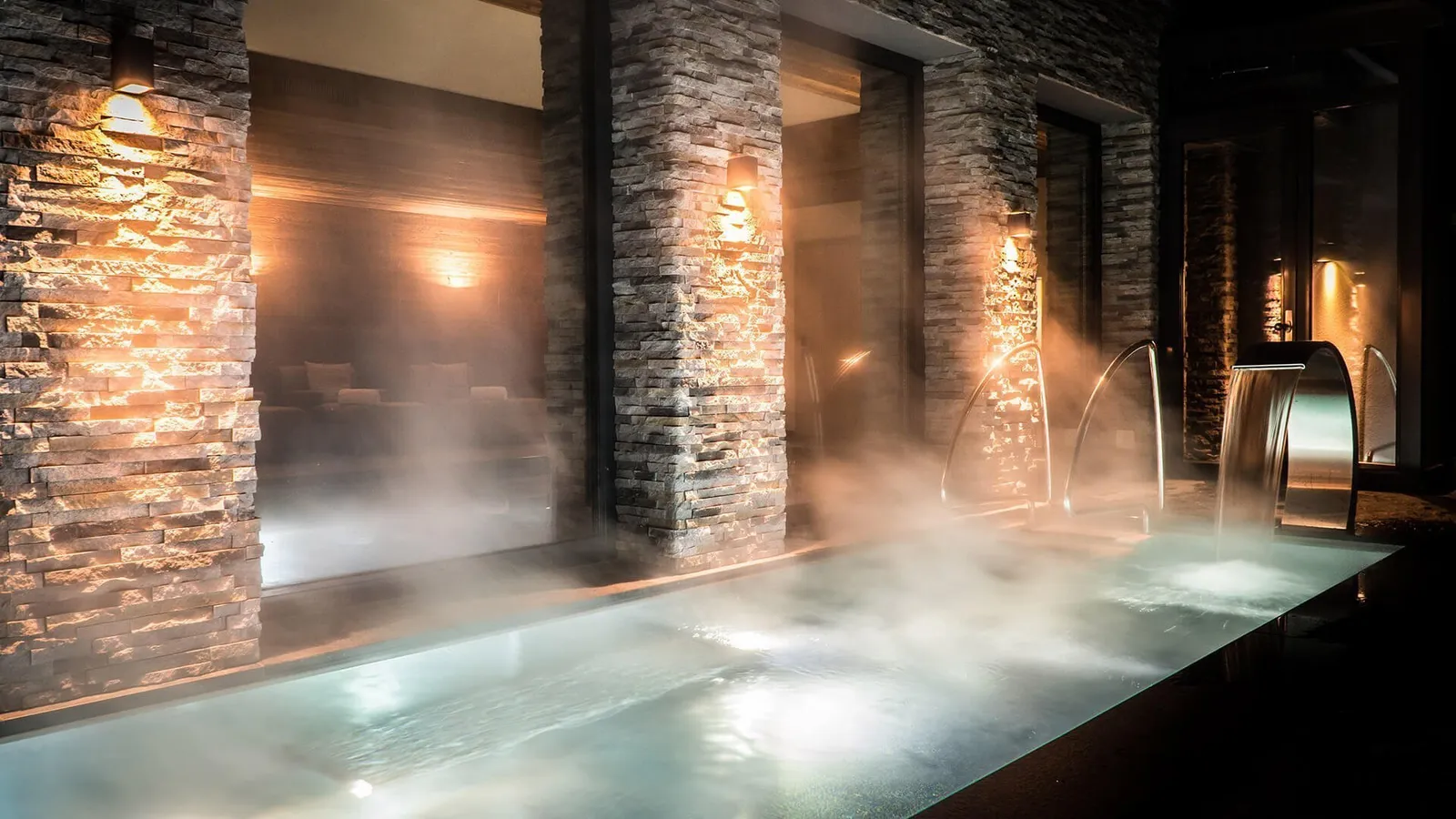 Una vasca della spa fra pareti di pietra