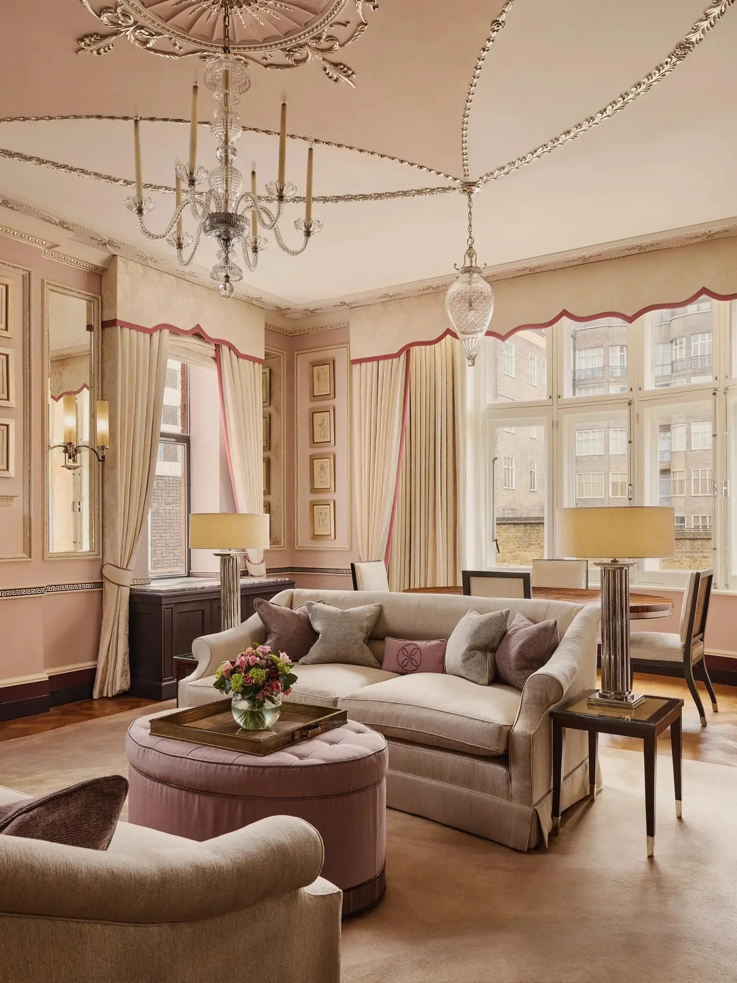 The Sutherland Suite: a domed ceiling with a chandelier, powder-pink sofas and a bright bay window