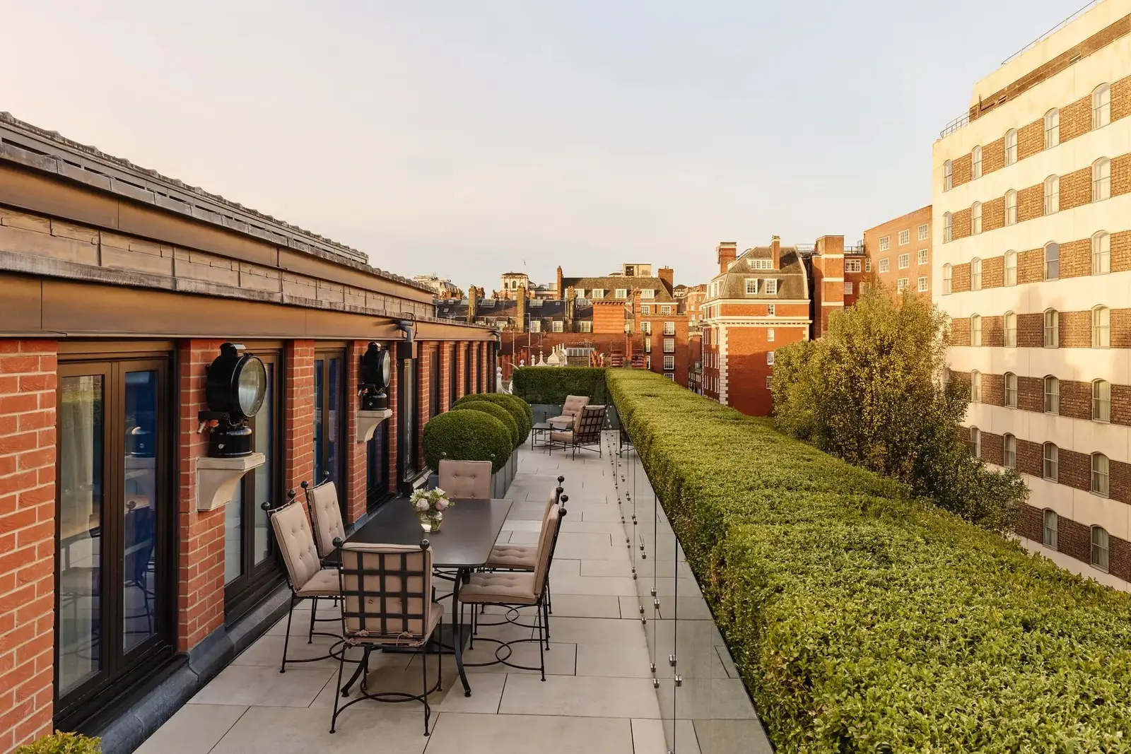 The Terrace Suite’s terrace: a long table between box hedges above the roofs of Mayfair