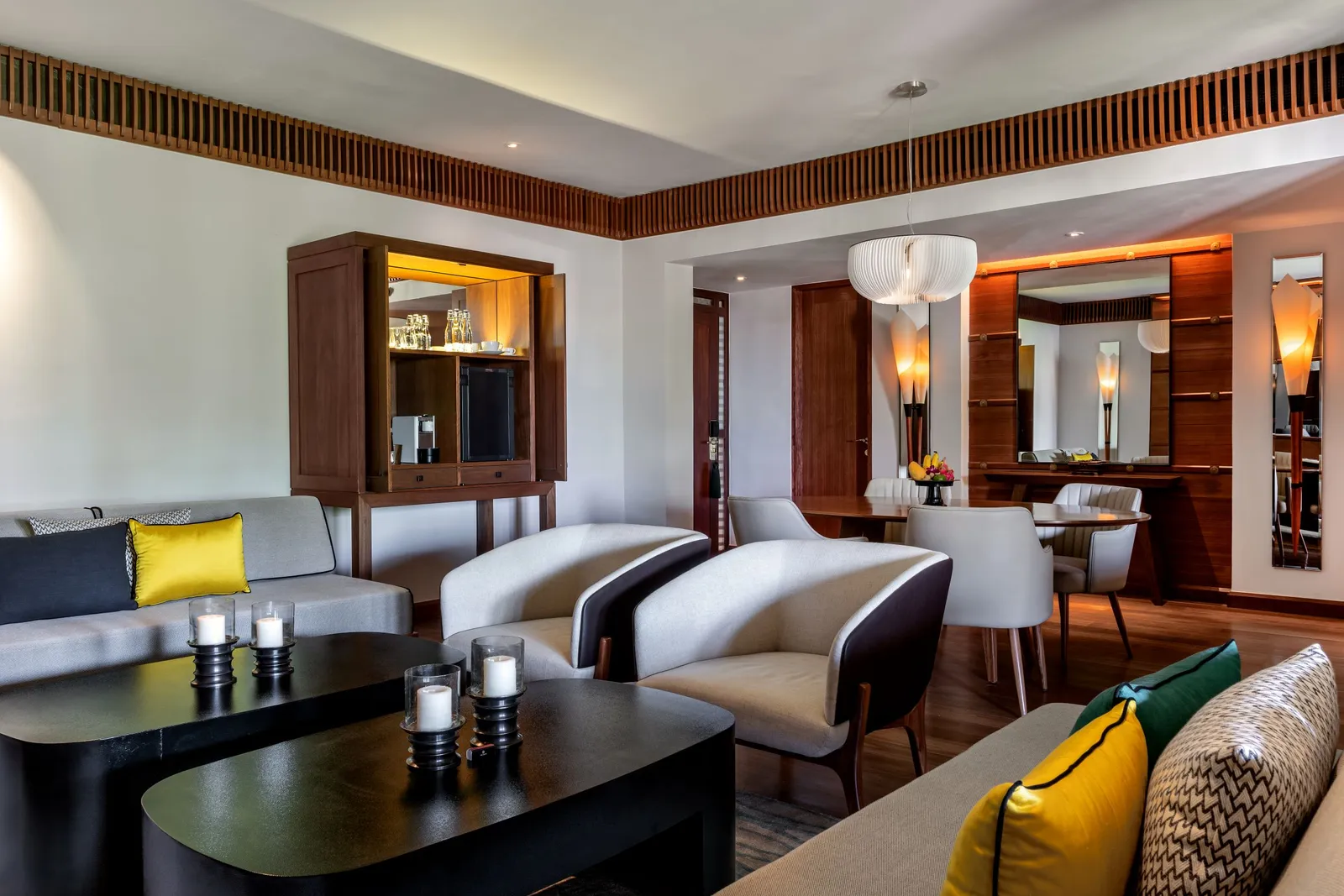 A Canopy Suite’s living and dining room under a coffered timber ceiling
