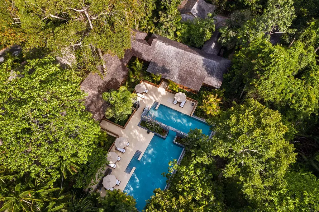 The Datai Estate Villa from above: roofs, decks and 2 connected pools in the forest