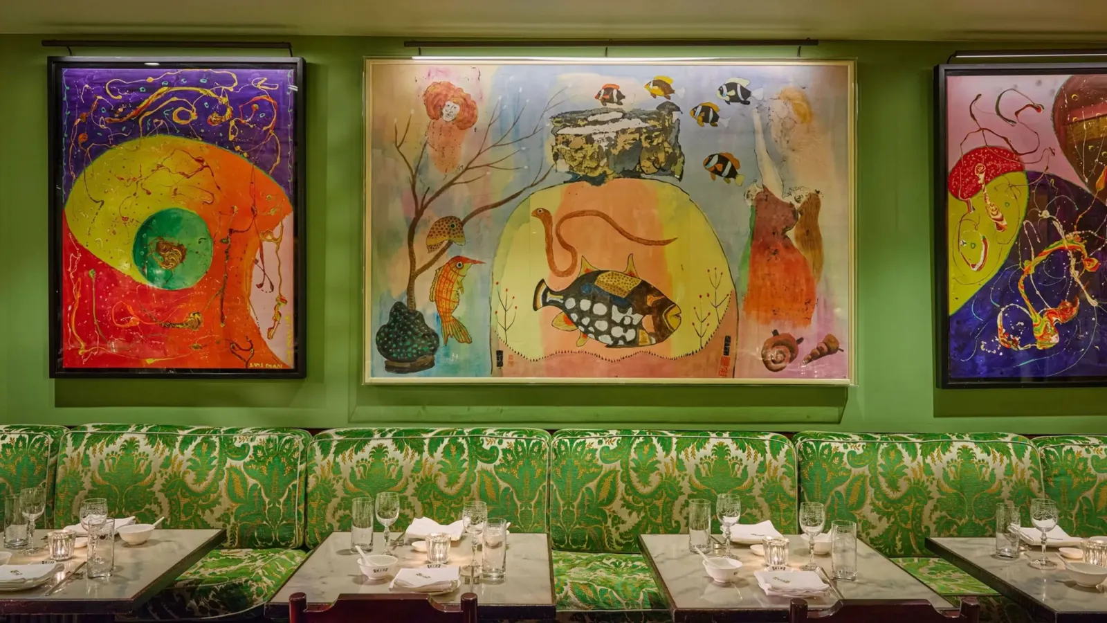 China Tang’s green dining room, hung with bright paintings