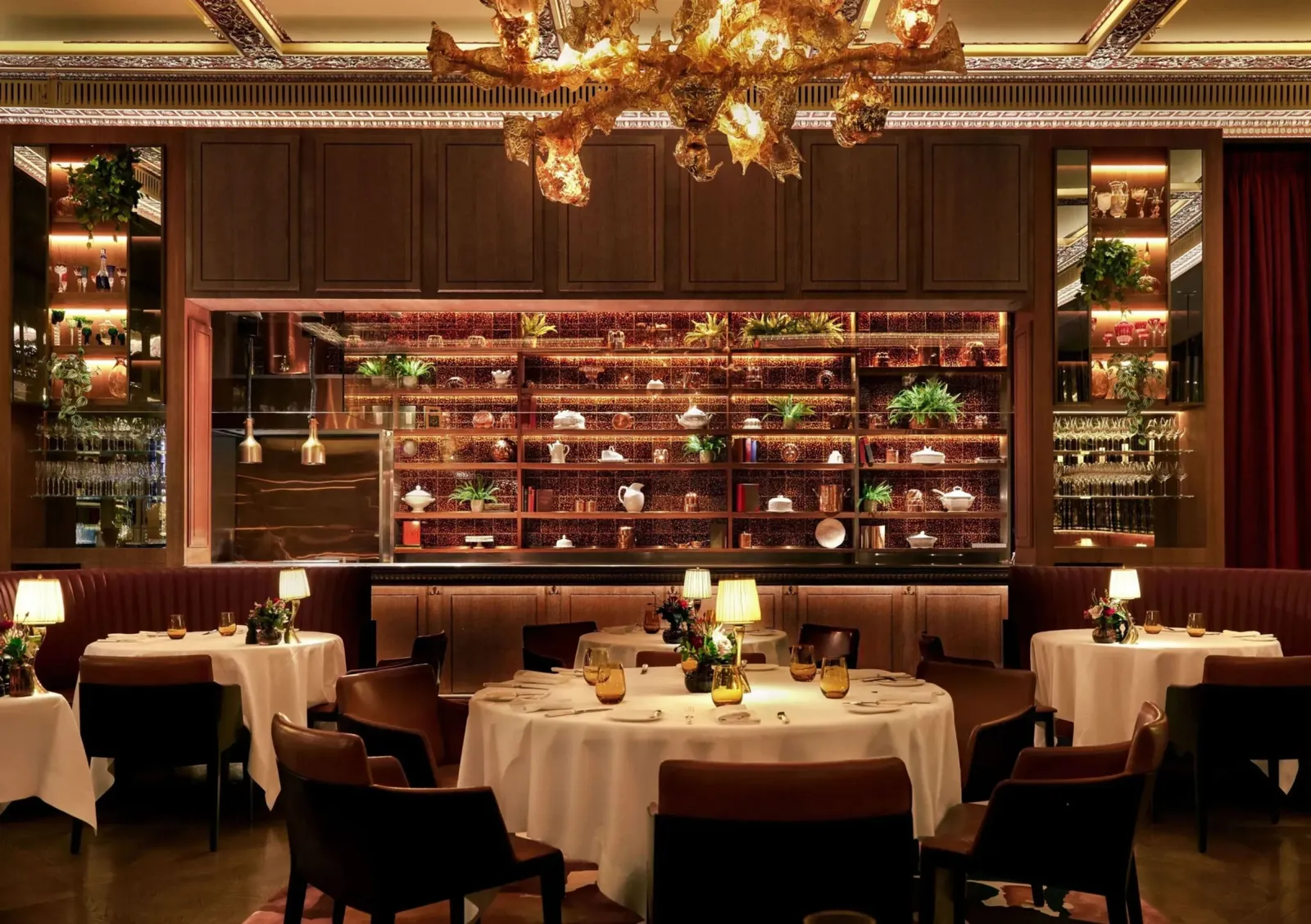 The Grill’s dining room, its golden chandelier above round tables