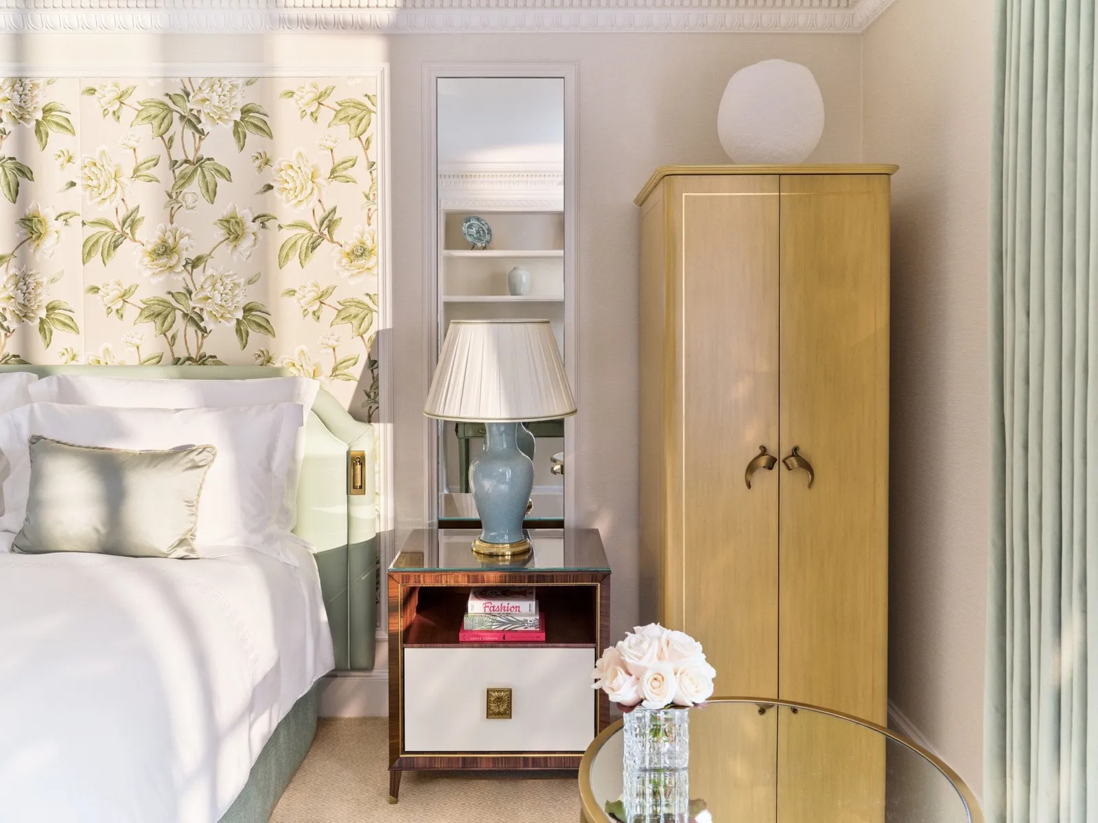A bedroom with floral wallpaper, as the official Classic Room page shows it
