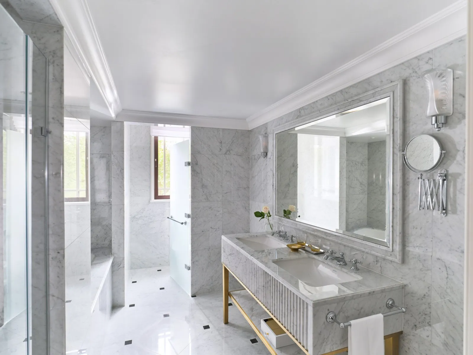 A Deluxe Room’s marble bathroom in morning light