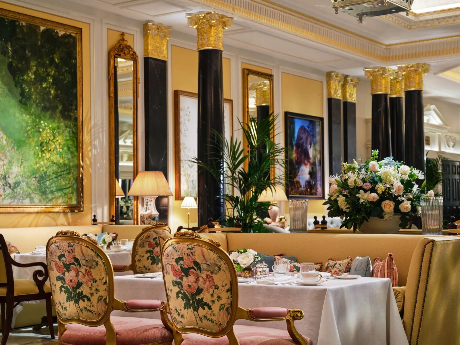 The Promenade laid for tea, among black columns and landscape paintings