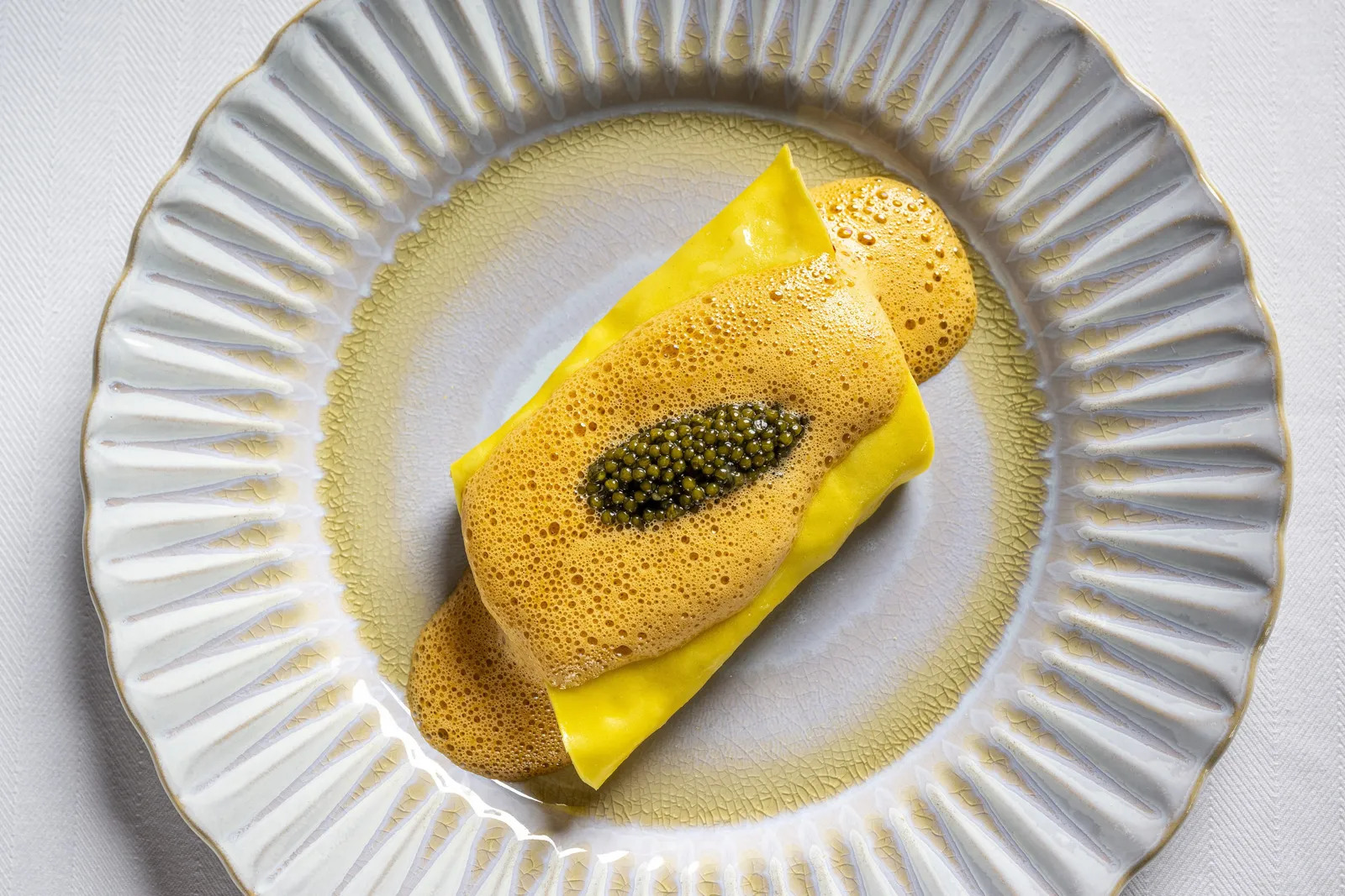Café Carmellini’s lobster cannelloni with caviar on a fluted white plate
