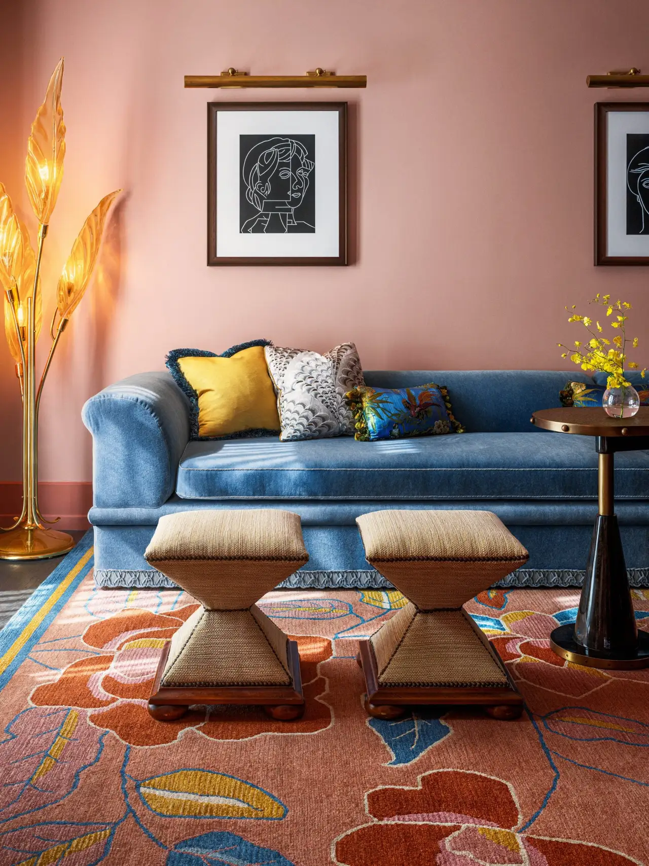 The Topiary Suite: a blue sofa and 2 stools against pink walls