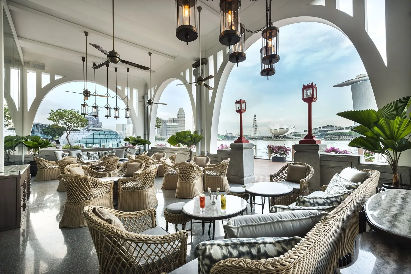 Clifford Pier’s veranda: wicker armchairs under the white arches, the red lamp posts and the bay with the observation wheel.