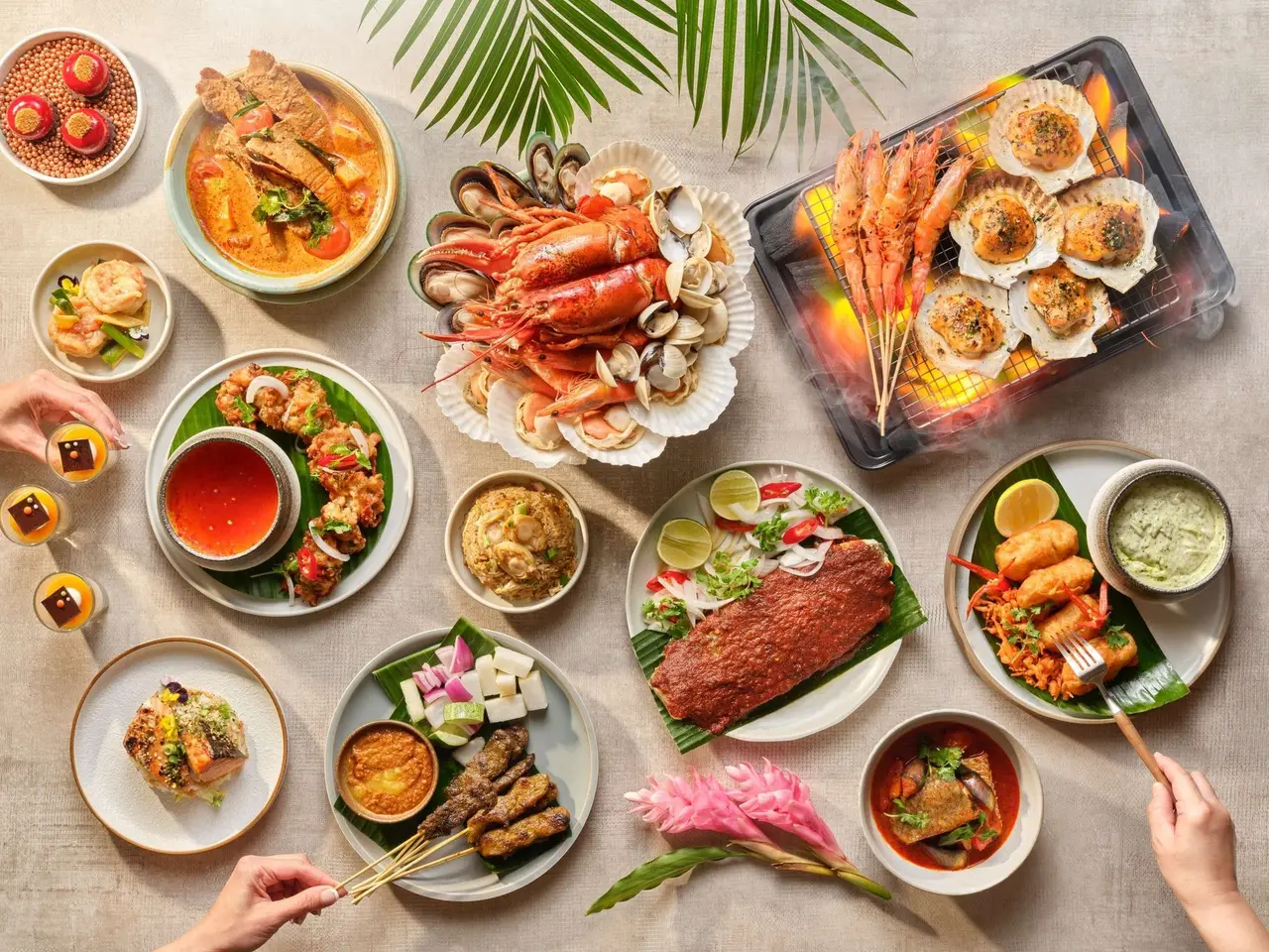 The Treasures of the Sea buffet seen from above: lobster and crab on ice, grilled scallops and prawns, satay and bowls of curry