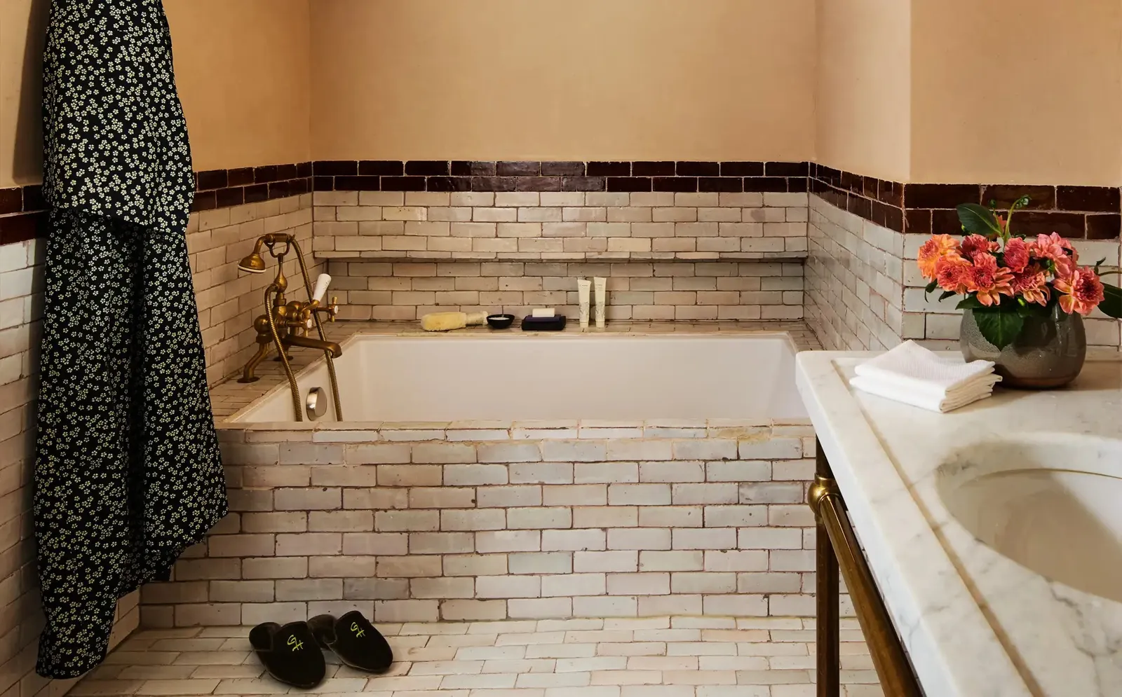 A Deluxe King bathroom: the tub among brown and white Moroccan tiles