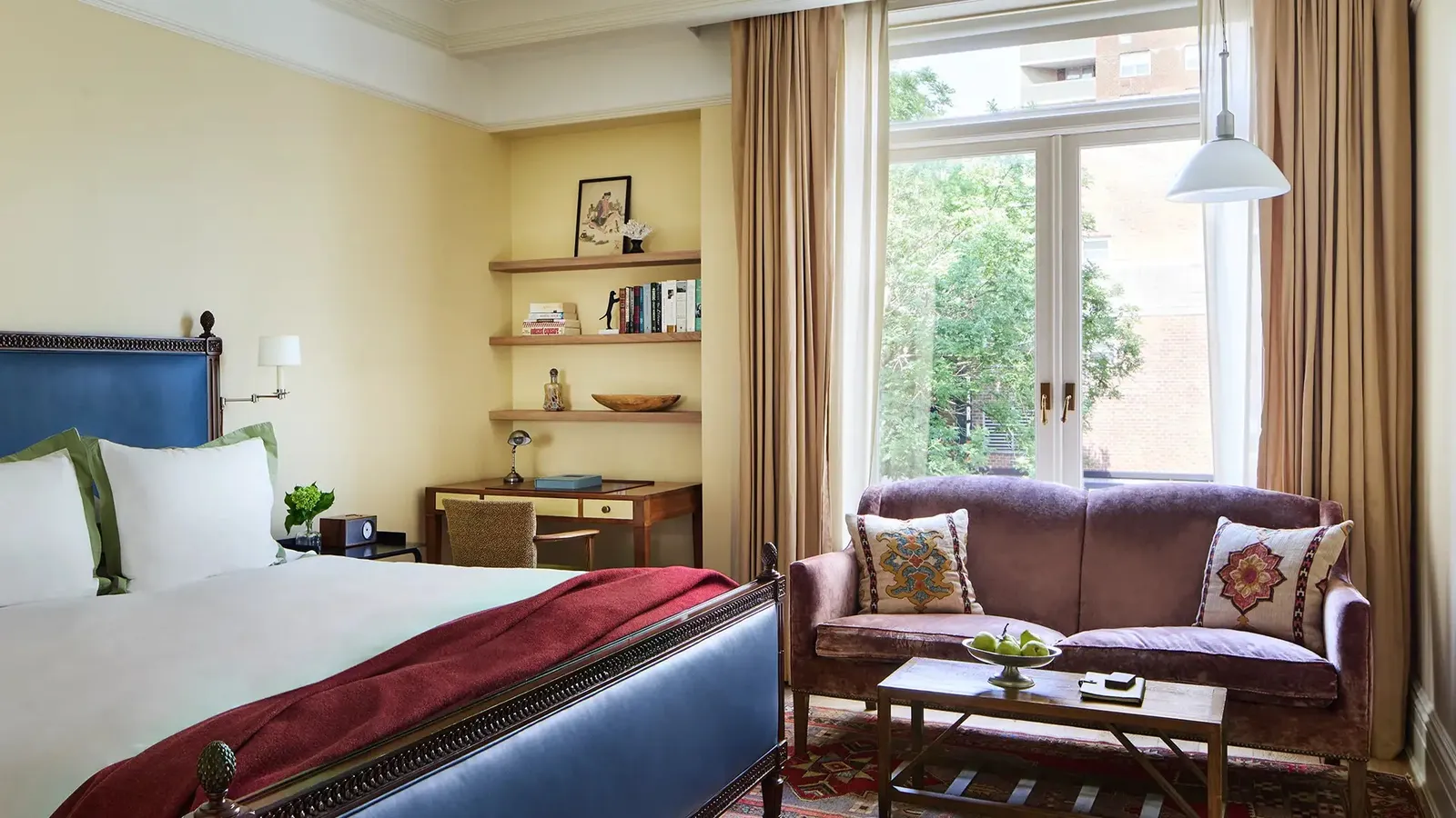 The Superior King Tub seen over the bed, the loveseat under the big window