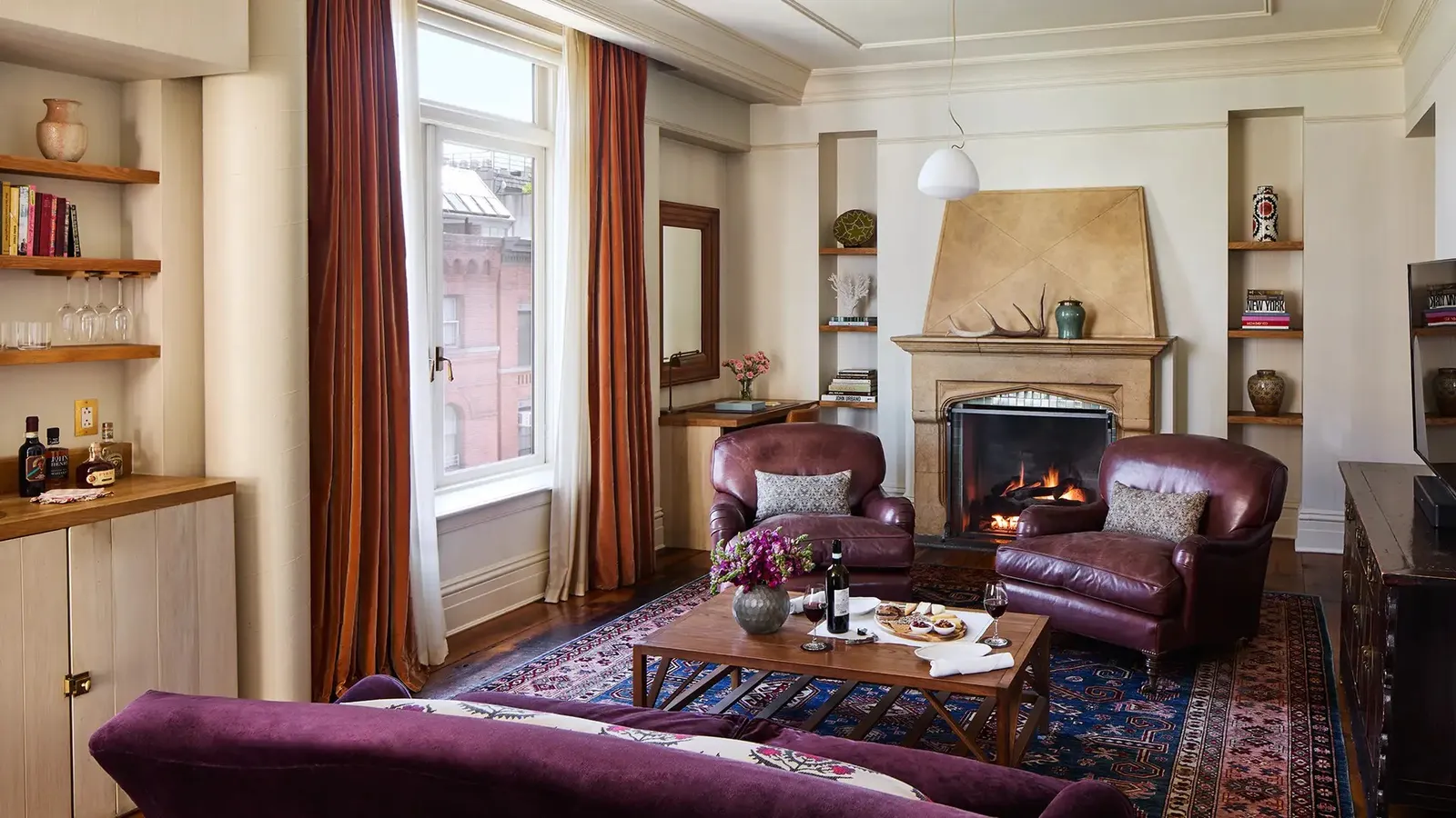 The 2 Bedroom Fireplace Corner Suite sitting room, the sofa between leather armchairs