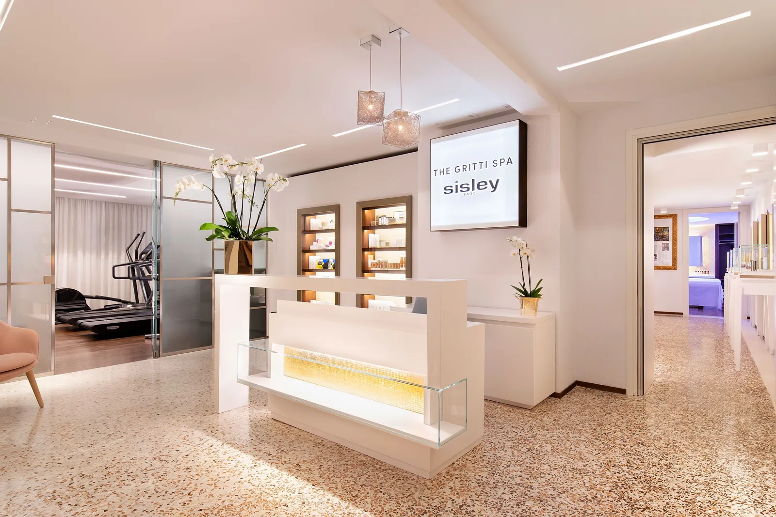 The Gritti SPA entrance: the white desk, niches of Sisley products, white orchids and a Venetian terrazzo floor.