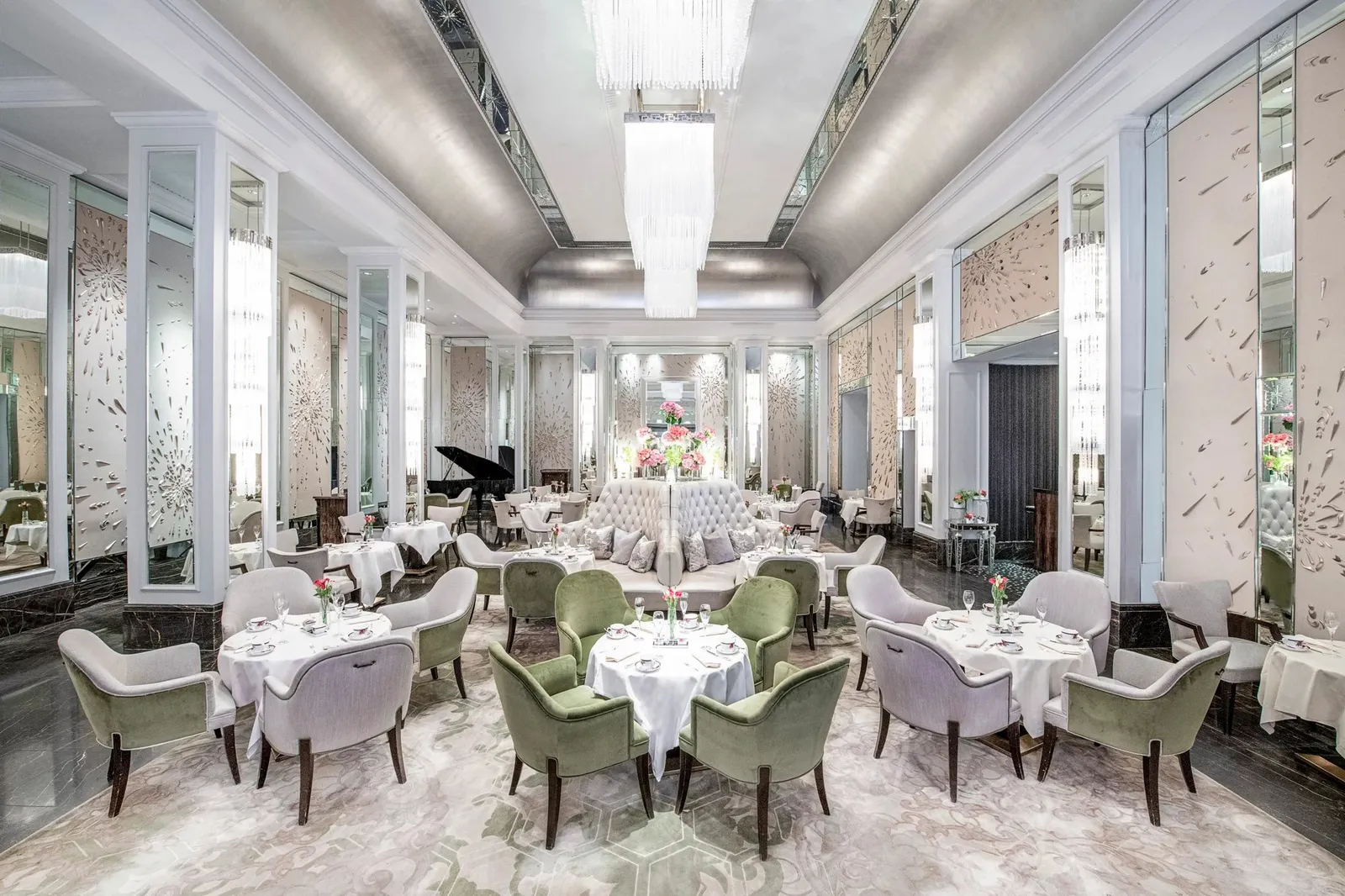 Palm Court: a crystal chandelier, sage-green armchairs and tables laid for tea