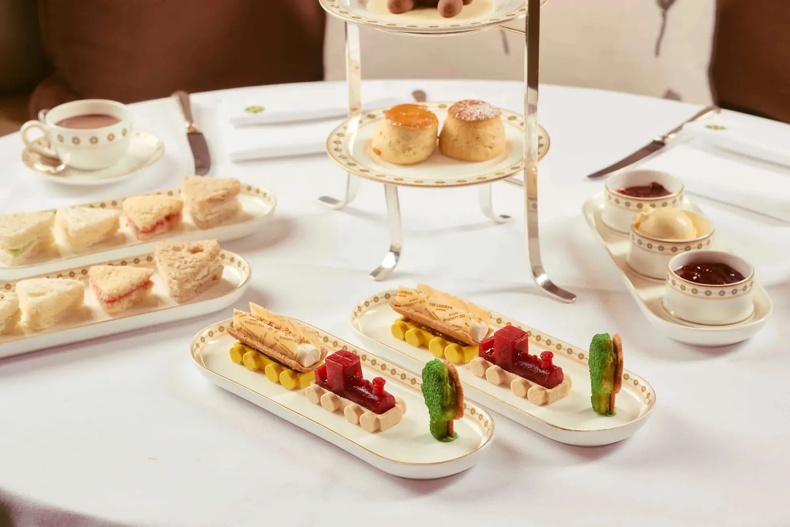 The children’s tea: finger sandwiches, scones and animal-shaped sweets on white plates