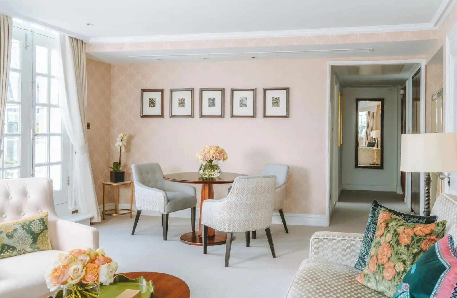 The Liberty Suite: a round dining table, powder-pink walls and floral-print cushions