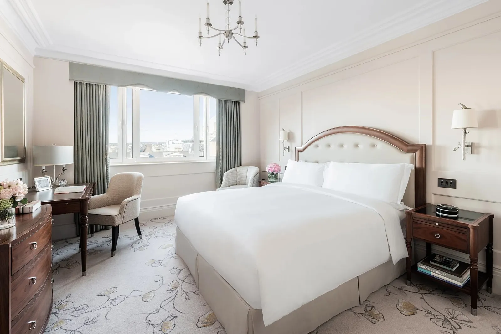 A Superior Room: a king bed, large windows onto a bright courtyard, an armchair and a desk