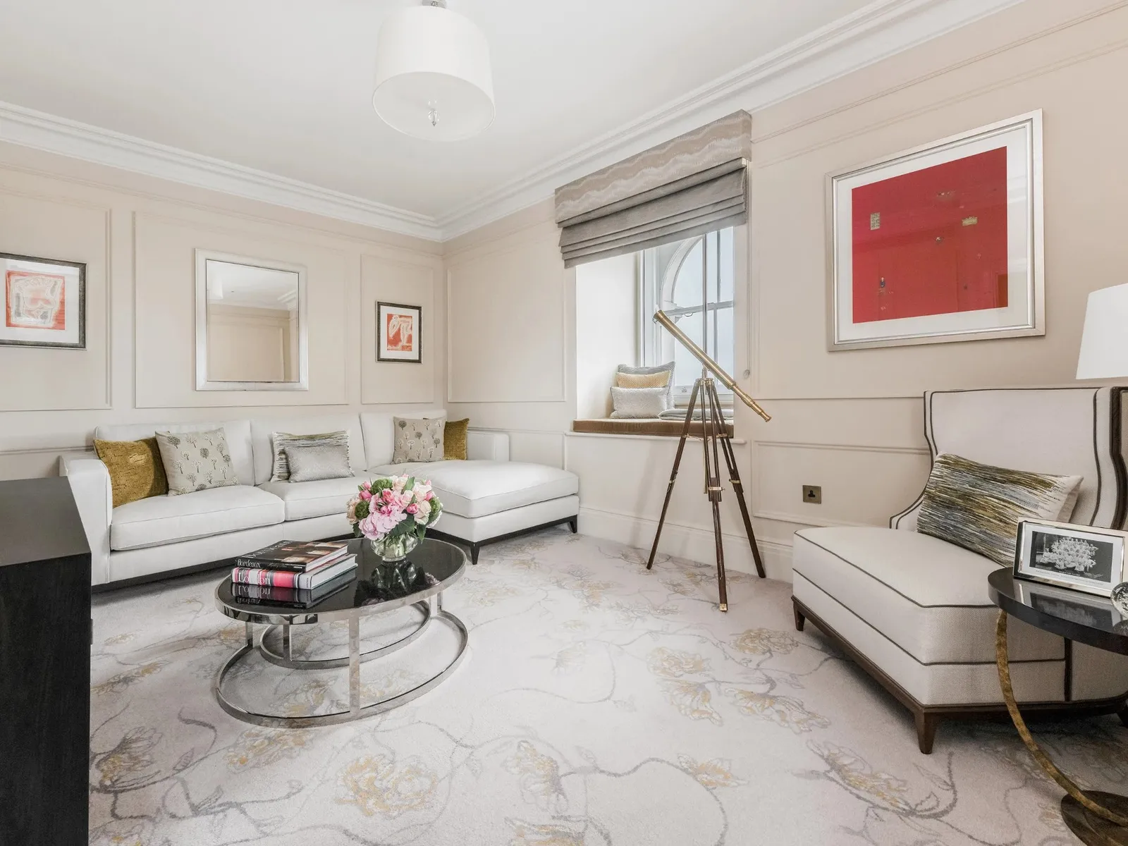 The Tower Suite’s sitting room: a white sofa and a telescope on a tripod by the window