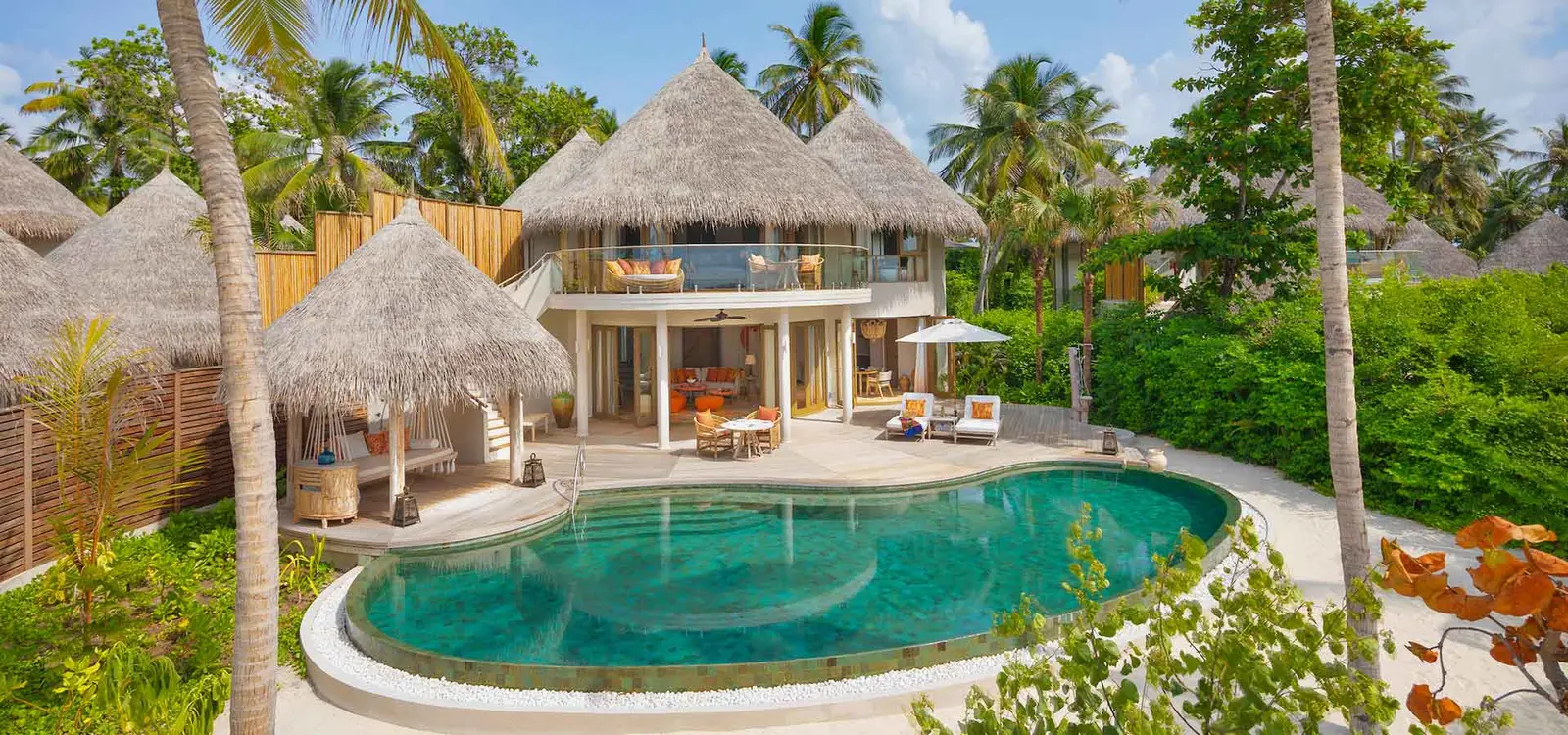The beach residence with its pool in front of the building.