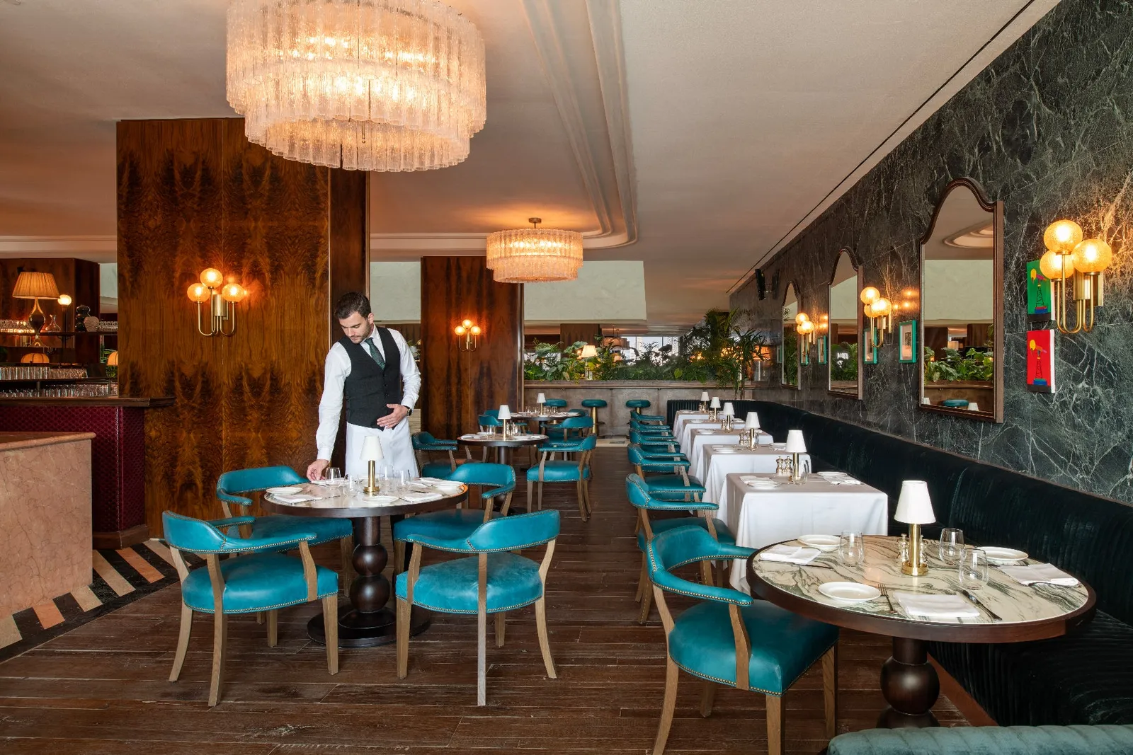 Cecconi’s dining room, turquoise chairs and laid tables
